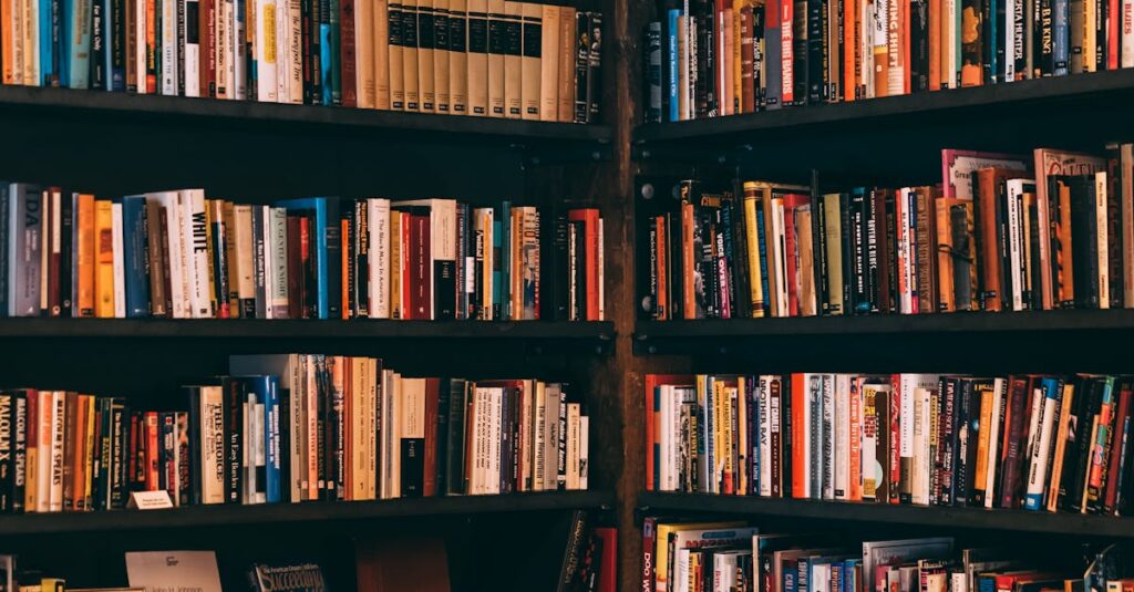 Corner view of a library with dark wooden bookshelves filled with a variety of books.